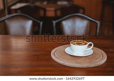 Coffee cups on a wooden table in a coffee shop