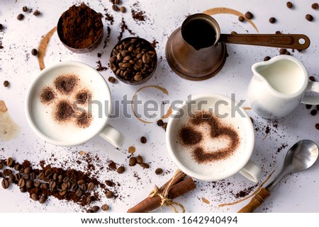 Copper coffee set and latte art hearts with coffee beans