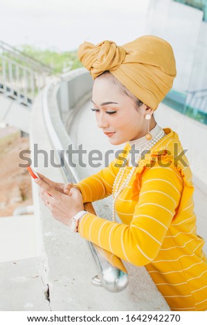 Muslim woman in hijab making selfie outdoors