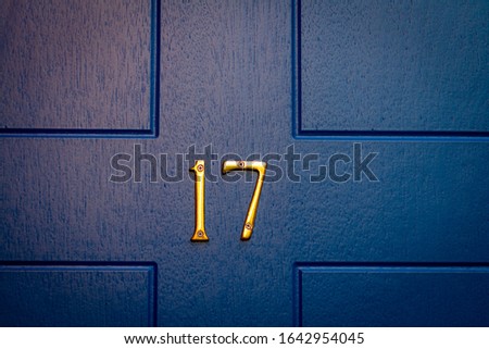 House number 17 on a blue wooden front door