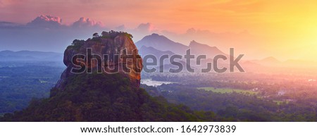 Panoramic view of the famous ancient stone fortress Sigiriya (Lion Rock) on the island of Sri Lanka, which is a UNESCO World Heritage Site. Royalty-Free Stock Photo #1642973839