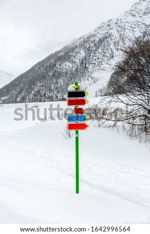 Signs on the track for winter sports on a background of snow and alpine mountains