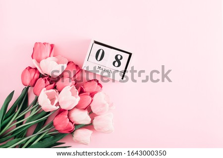Beautiful pink tulips and calendar on pastel pink background. Concept Women's Day, March 8. 8th march. Flat lay, top view, copy space Royalty-Free Stock Photo #1643000350