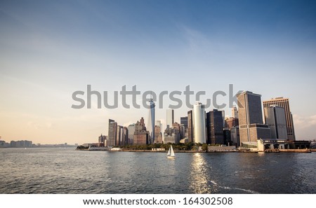 Panoramic image of lower Manhattan skyline with reflections.