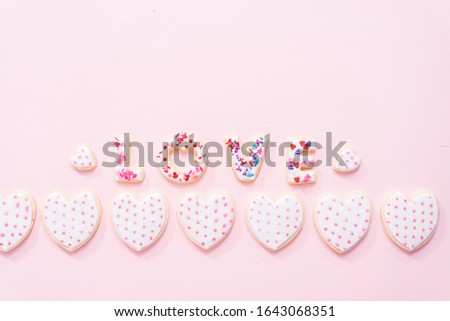 Flat lay. sugar cookies decorated with royal icing for Valentine's Day  on a pink background.
