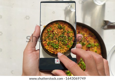 Woman photographing on cell phone homemade healthy food