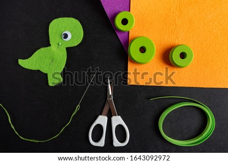 Felt crafts. dragon from felt. Instruction how to make dragon. Crafts for kids.Creating felt owl crafts. Top view