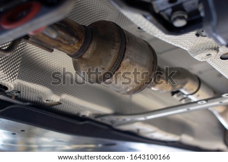 Catalytic converter of a modern car bottom view. Royalty-Free Stock Photo #1643100166