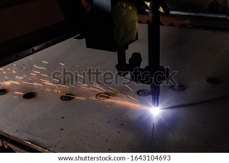 Plasma cutting of metal with a cnc. Plasma cutting machine cutting steel sheet. Laser cutter in production. Industrial metal cutting by plasma laser