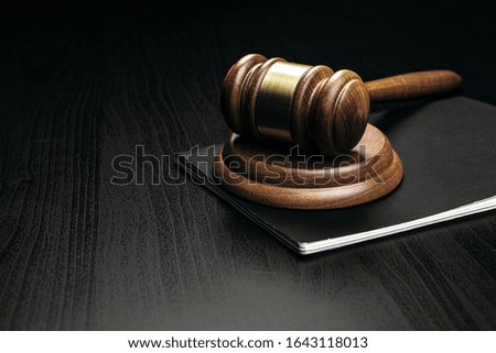 Image of wooden judge hammer on notepad