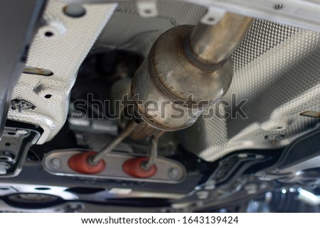 Catalytic converter of a modern car bottom view. Royalty-Free Stock Photo #1643139424