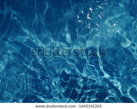 Abstract​ of​ surface​ blue​ water​ in​ the​ deep​ sea​ for​ background. Surface​ blue​ water​ reflected​ by​ sunlight​ for​ background​