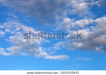 Beautiful white clouds on the natural background of the blue sky.