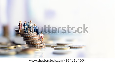 Miniature people: Elderly people sitting on coins stack. social security income and pensions. Money saving and Investment. Time counting down for retirement concept. Royalty-Free Stock Photo #1643154604