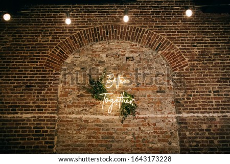 Better Together - neon sign on a brick wall in a restaurant at a wedding party. Love concept Royalty-Free Stock Photo #1643173228