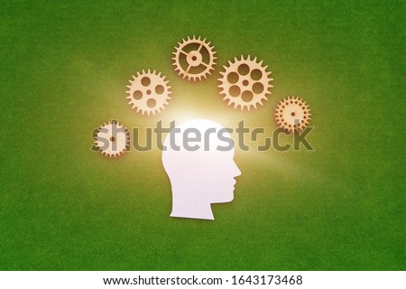 silhouette of a human head, gears on a green background. creative ideas.