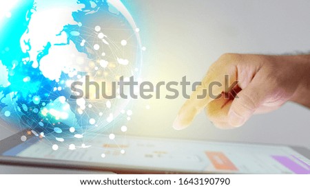 hand touching tablet and global network on screen