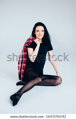 Young adult woman posing wearing total black. Casual outfit.Ballerina style.