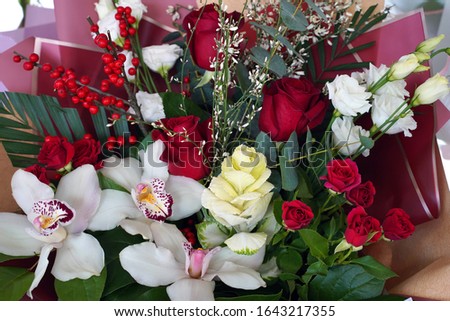   stylish bouquet of different red and white flowers                             