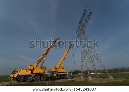 Removing old electricity pylons requires heavy equipment