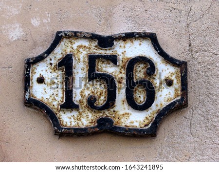            Vintage grunge square metal rusty plate of number of street address with number. Close up, brand.                    