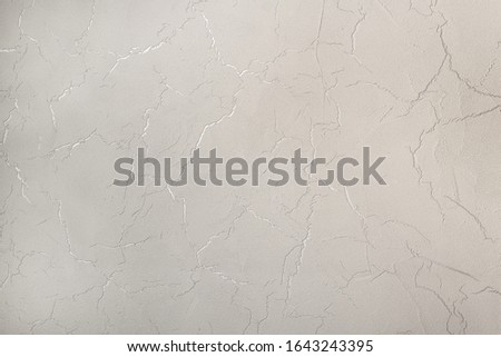 gray textured decorative stucco wall closeup. background picture on the wall