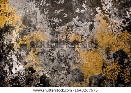 Textured decorative plaster on the wall gold, black, silver color. background picture on the wall
