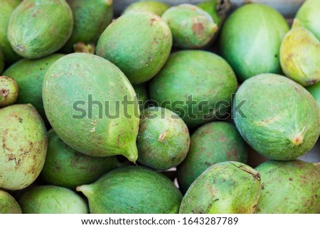 box full of green mangoes