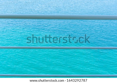 Sea for background in beautiful color of aqua menthe. With three white lines in front of it. Beautiful and calm photo. 