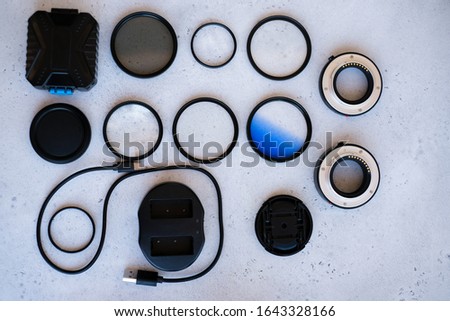 Flat lay composition with equipment for professional photographer on grey background