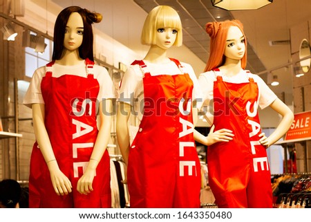 mannequins with clothing and lettering, sale. Promotion of sales of goods. Advertising sign for a sale in a boutique