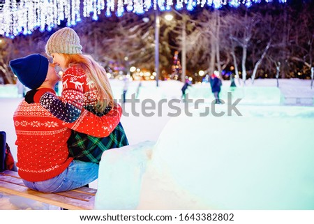 Woman and man hands in winter gloves heart symbol. Concept feelings love and freedom with sunset night background bokeh.