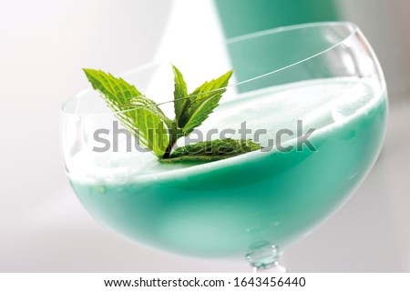 Peppermint cream liqueur garnished with peppermint leaves