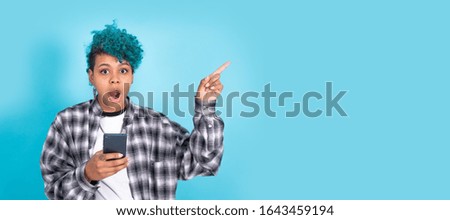 african american girl or woman with mobile phone or smartphone isolated on blue background