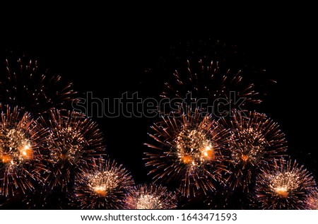 golden fireworks on black background with sparks