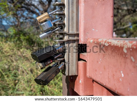 Overkill with six different padlock locks securing a metal gate from being opened Royalty-Free Stock Photo #1643479501