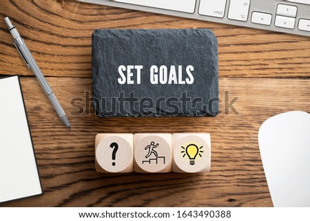 SET GOALS - idea concept in an office scene on wooden background Royalty-Free Stock Photo #1643490388