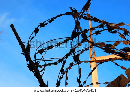Barbed wire with sky background.