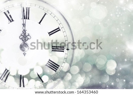 New Year's at midnight - Old clock with stars snowflakes and holiday lights  Royalty-Free Stock Photo #164353460