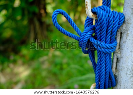 Blue Rope Knot on a Metal Pole