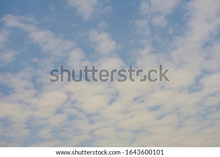 The background image of clean white clouds against the bright sky in the morning.