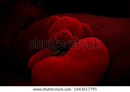 Still life Red teddy bear and red heart on black backgrounds for Valentine day