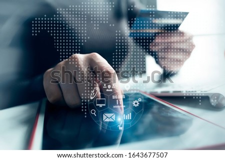 Double exposure of businesswoman holding credit card and using tablet. Online shopping concept . Finance task. Digital tablet with virtual icon diagram.