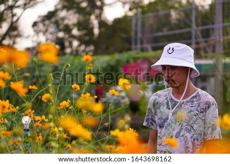 Young man in the farm with flower