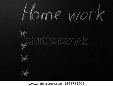 the inscription "homework" written in white chalk on a black chalkboard. Template for listing list.