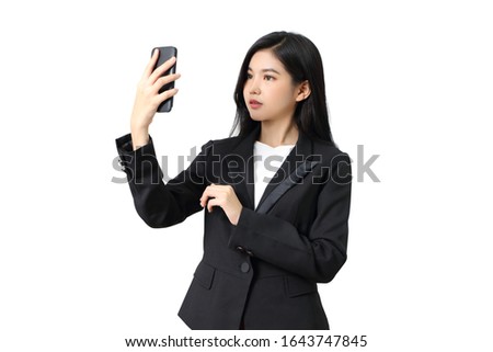 young asian businesswoman holding her smartphone on white background in studio