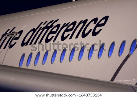 
aircraft side with blue illuminated portholes