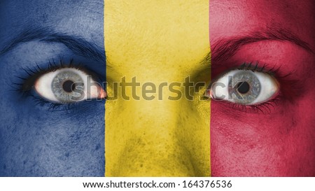 Close up of eyes. Painted face with flag of Chad