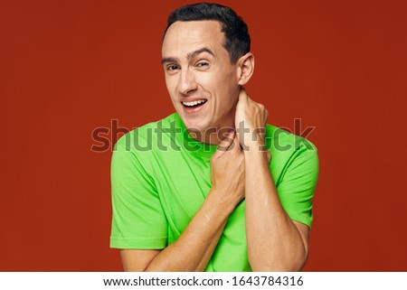 Red background green shirt handsome man