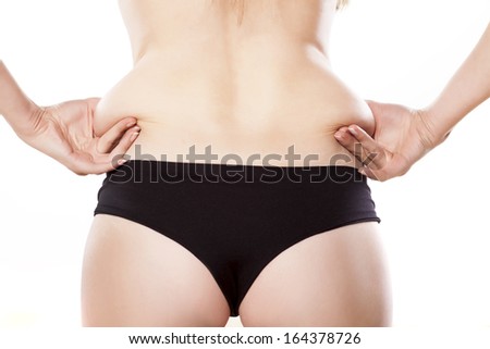 Adult female pinching skin on the waist for test